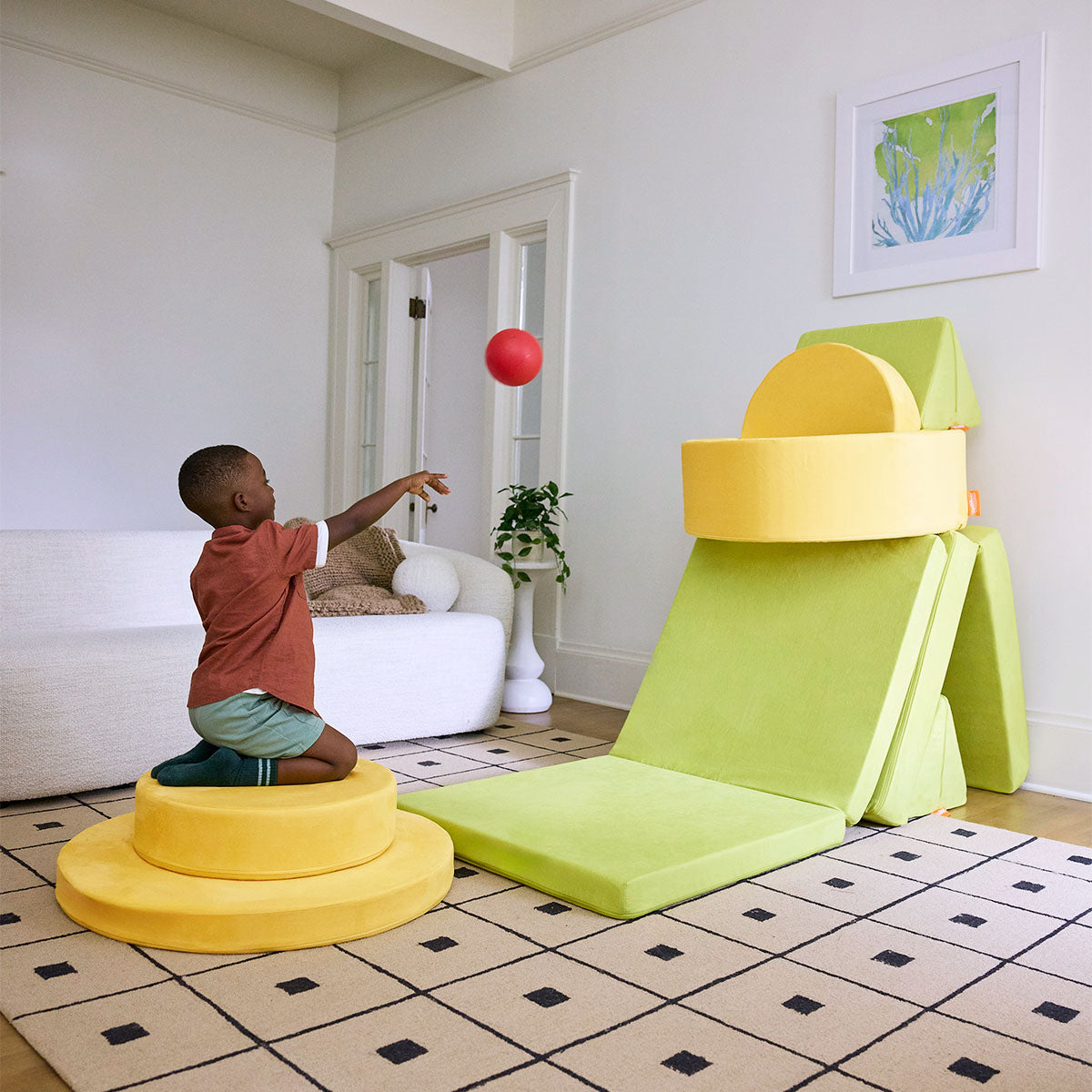 A child plays a game with Nugget play furniture set up in a Nugget-Chunk basketball hoop build.