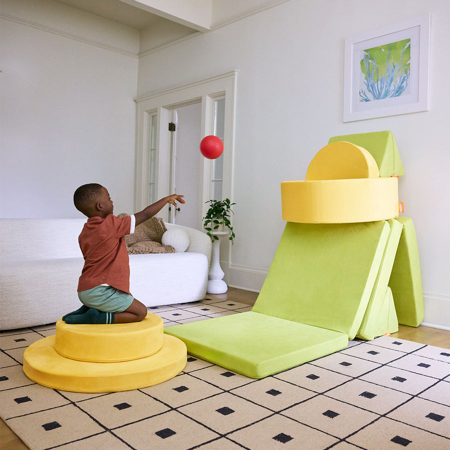 A child plays a game with Nugget play furniture set up in a Nugget-Chunk basketball hoop build.