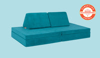 An Atlantis peacock teal Nugget play couch set up in a kids' sofa configuration.