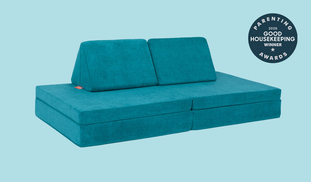 An Atlantis peacock teal Nugget play couch set up in a kids' sofa configuration.
