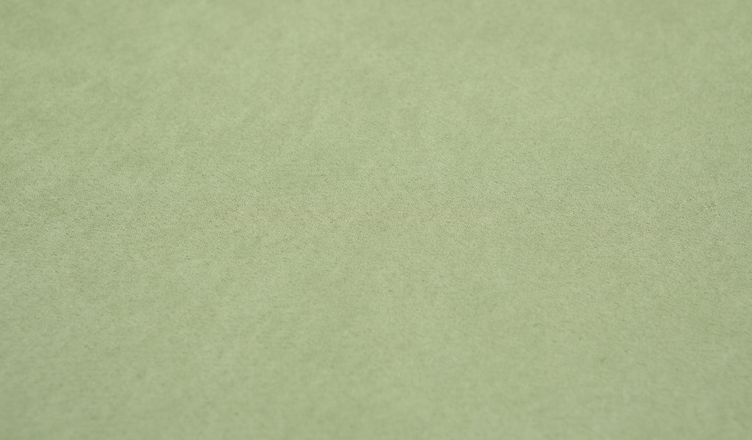 Close-up of the smooth, suede-like Nugget microsuede fabric in mossy sage Bamboo.