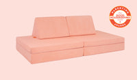 A Blossom light peach Nugget play couch set up in a kids' sofa configuration.