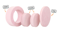 Four pieces of a blush pink Chunk play ottoman lined up: one large hoop, two sturdy nesting, and one wider pad for the lid.