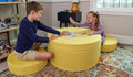 Kids playing a card game on the Lemonade Chunk™ play ottoman