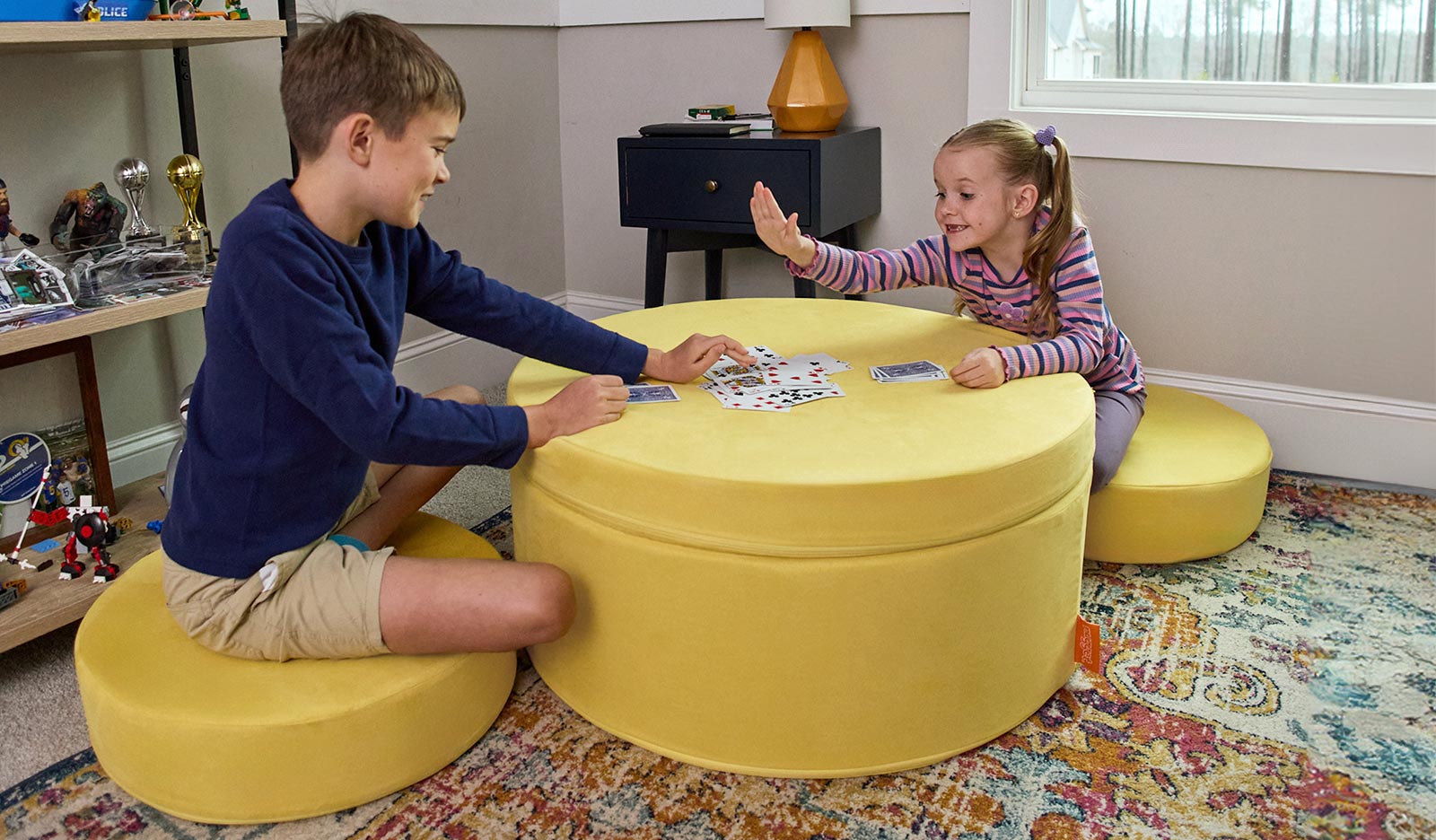 Kids playing a card game on the Lemonade Chunk™ play ottoman