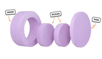 Four pieces of a lilac purple Chunk play ottoman lined up: one large hoop, two sturdy nesting, and one wider pad for the lid.