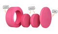 Four pieces of a hot pink Chunk play ottoman lined up: one large hoop, two sturdy nesting, and one wider pad for the lid.
