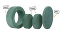 Four pieces of a sea green Chunk play ottoman lined up: one large hoop, two sturdy nesting, and one wider pad for the lid.