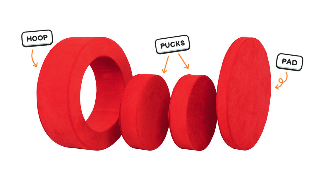 Four pieces of a true red Chunk play ottoman lined up: one large hoop, two sturdy nesting, and one wider pad for the lid.