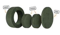 Four pieces of a forest green Chunk play ottoman lined up: one large hoop, two sturdy nesting, and one wider pad for the lid.