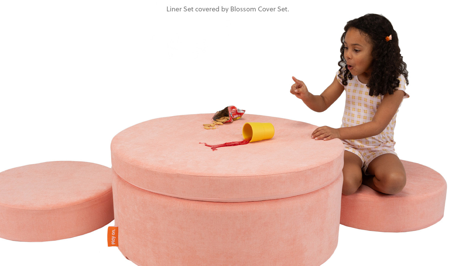 Girl spilling juice on the Chunk™ cover set