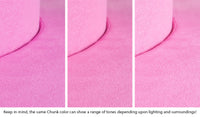 Close-up of a Chunk puck in Lolly candy pink across three lighting situations. One color can present as a range of tones depending on the room.
