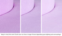 Close-up of a Chunk puck in Moonshot lilac purple across three lighting situations. One color can present as a range of tones depending on the room.