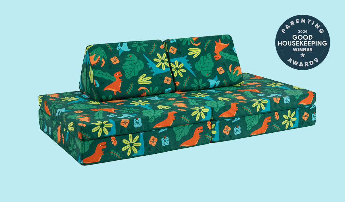 A lively dinosaur-patterned Nugget play couch set up in a kids' sofa configuration.