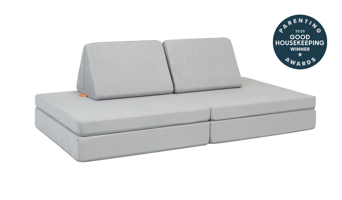 A Koala light gray Nugget play couch set up in a kids' sofa configuration.