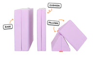 Four pieces of a lilac purple Nugget play couch lined up: one foldable base, one foldable cushion, and two triangular pillows.