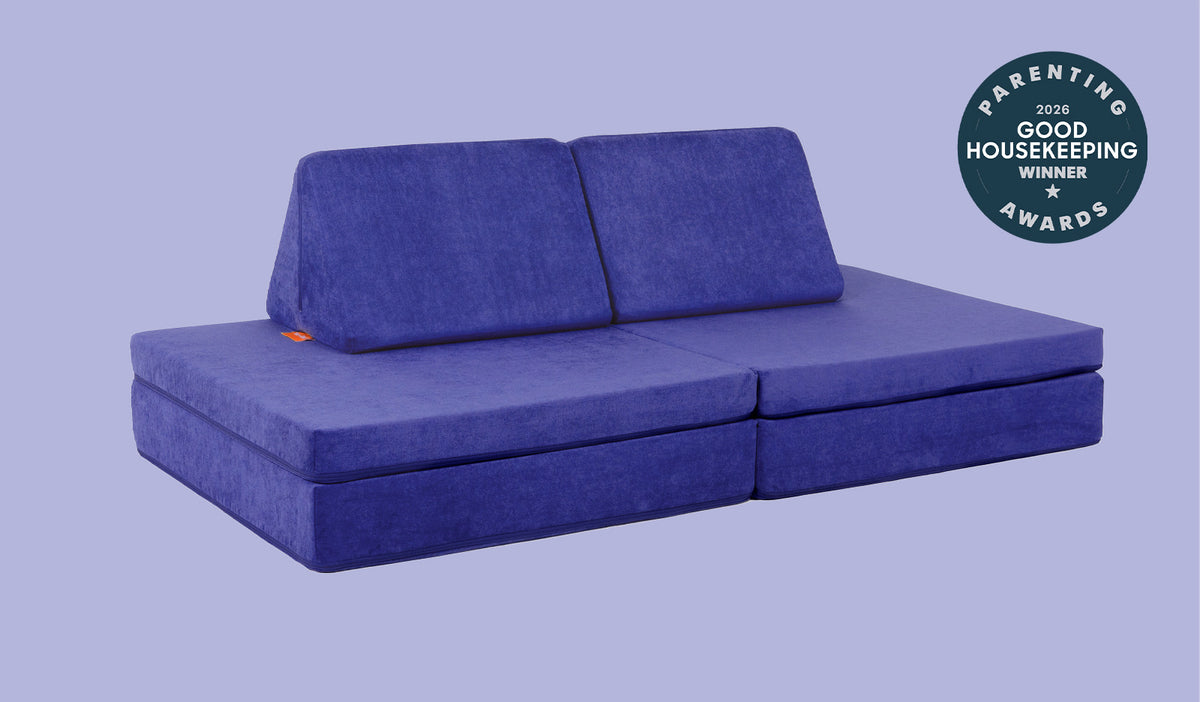 A Nebula vibrant indigo Nugget play couch set up in a kids' sofa configuration.