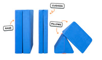 Four pieces of a cobalt blue Nugget play couch lined up: one foldable base, one foldable cushion, and two triangular pillows.