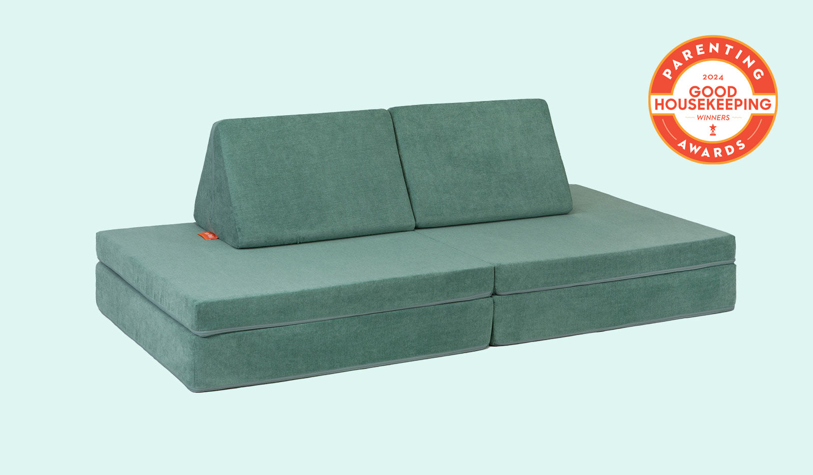 A Seamonster sea green Nugget play couch set up in a kids' sofa configuration.