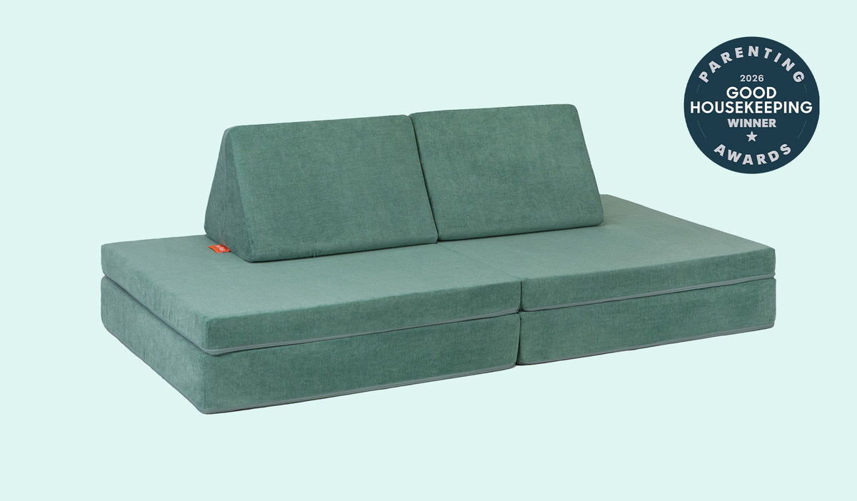 A Seamonster sea green Nugget play couch set up in a kids' sofa configuration.