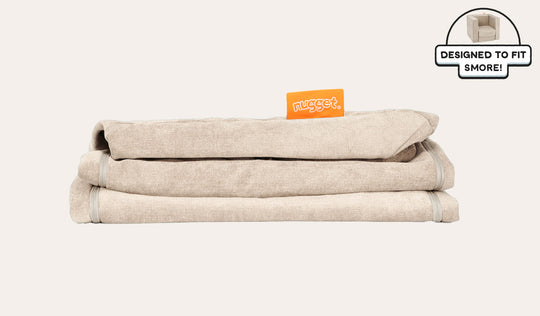 A neatly folded and stacked Smore Cover Set in vintage beige Dunebuggy.
