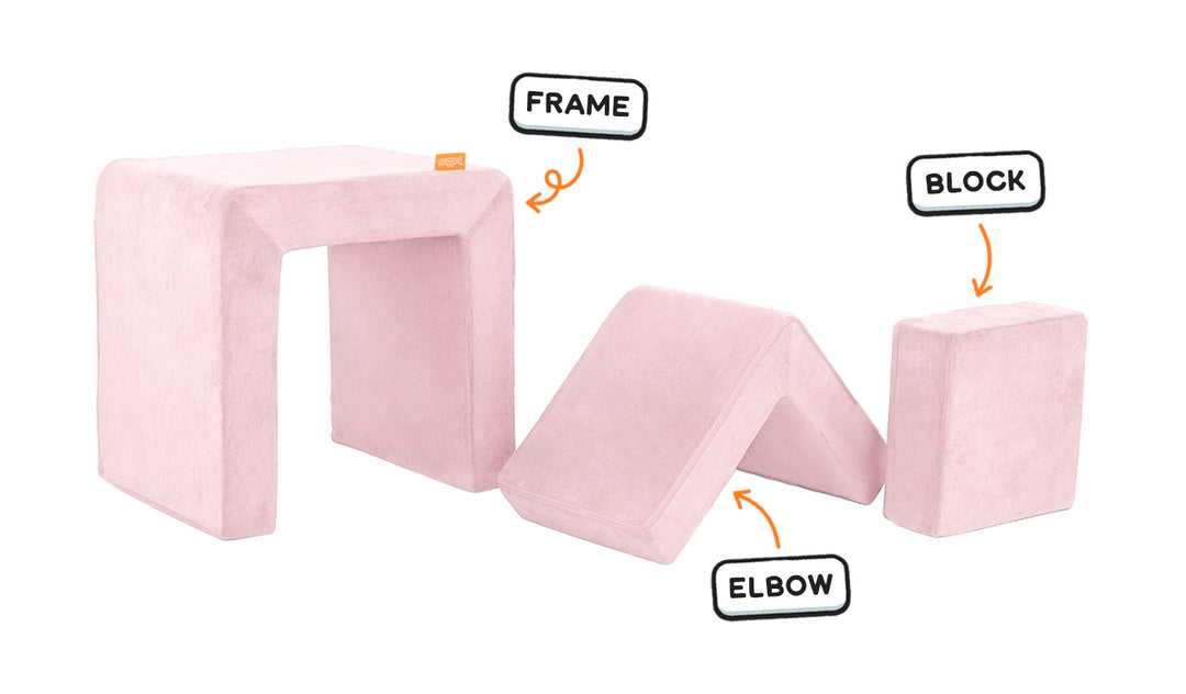 Four pieces of a blush pink Smore play chair lined up: sturdy frame, one L-shaped elbow, and one square block.