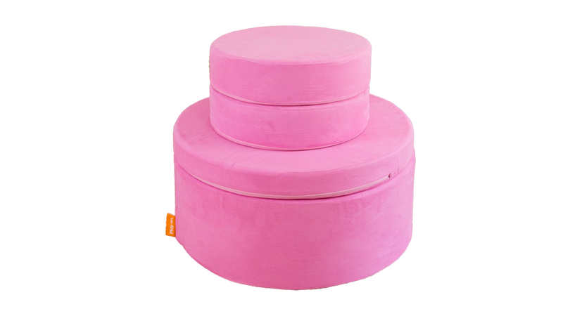 One candy pink play ottoman is set up like a tower build.