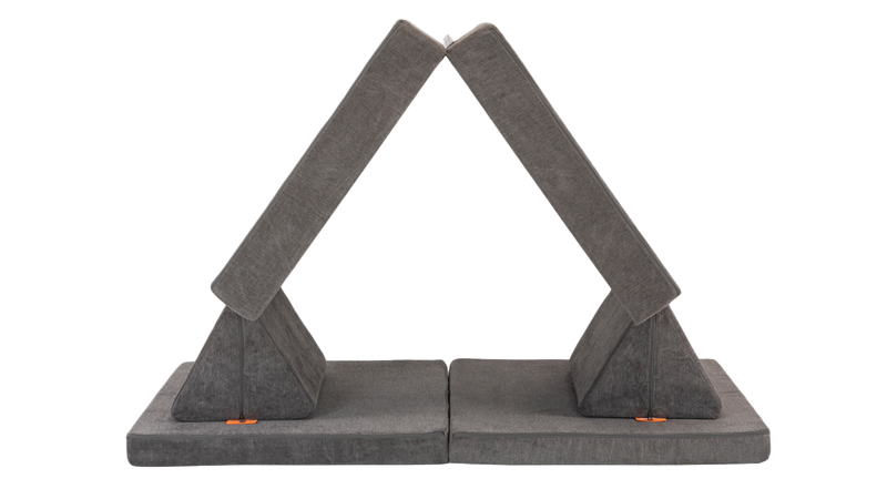 One dark gray Nugget play couch is set up like a fort.
