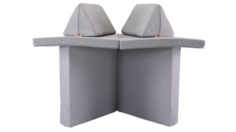 One light gray Nugget play couch forms a cozy shelter build, ready for imaginative play.