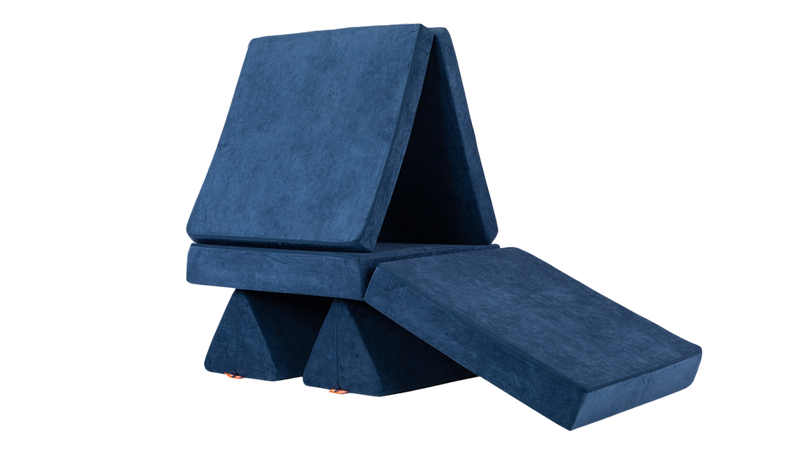 One navy blue Nugget play couch is ready for playtime as a treehouse build with a ramp up to the front.