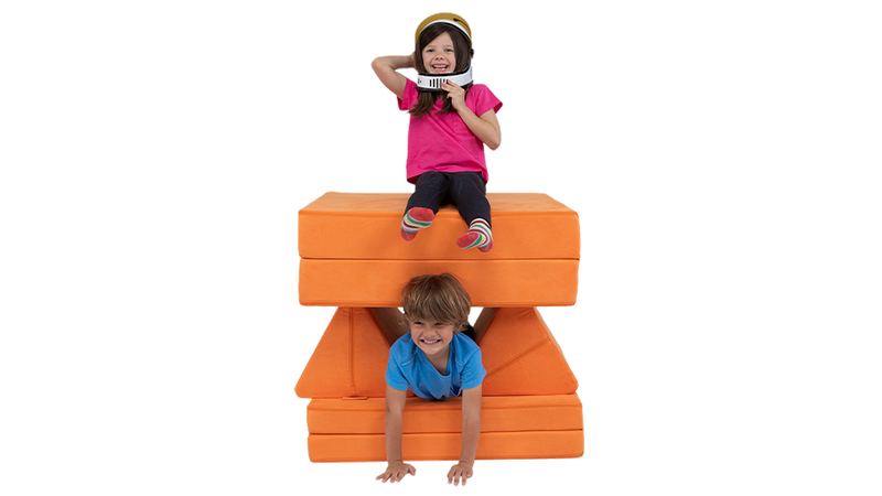 Two children blast off into pretend space aboard a one-Nugget spaceship build, made from an orange play couch.