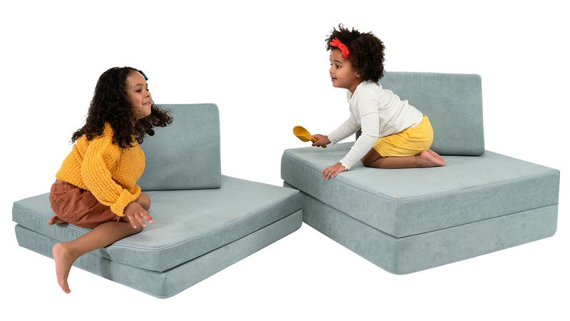 wo children play on a light blue Nugget play couch, set up to look like two chairs.