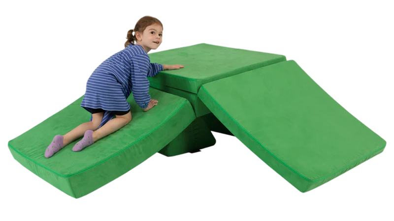 A child crawls up a one-Nugget slide build — created with a kelly green Nugget play couch.