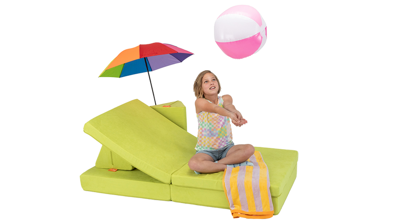 A child taps a beach ball and plays on a one-Nugget beach lounge build, made from a chartreuse Nugget play couch.