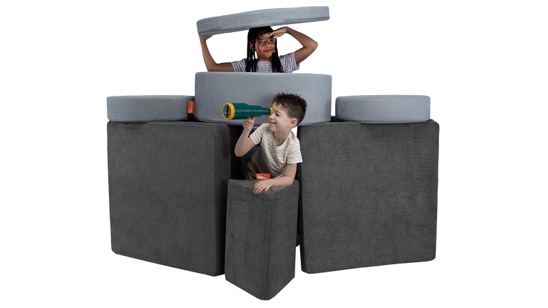 Two kids play in a foam play furniture submarine, built from one Nugget play couch and one Chunk play ottoman.