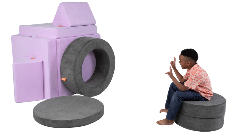 A child uses one Nugget, one Chunk, and his imagination to pretend he’s posing for a life-sized camera lens.