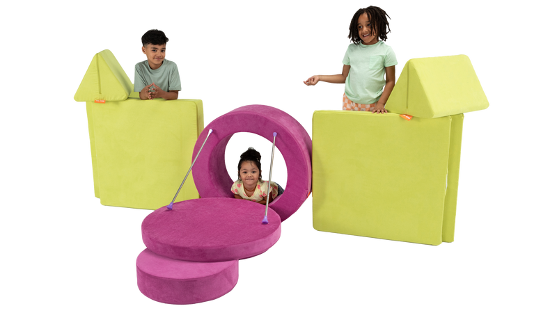 Three kids play on a colorful castle made from one Nugget play couch and one Chunk play ottoman, complete with a drawbridge.