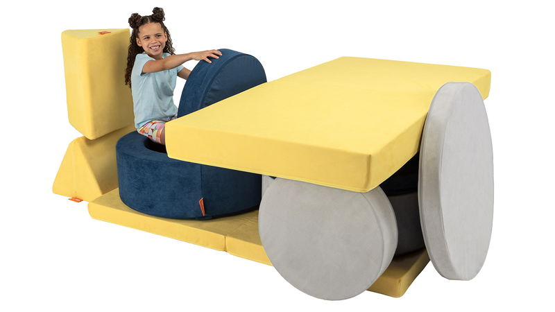 A child plays in a colorful biplane build, created with two Chunk play ottomans and one Nugget play couch.