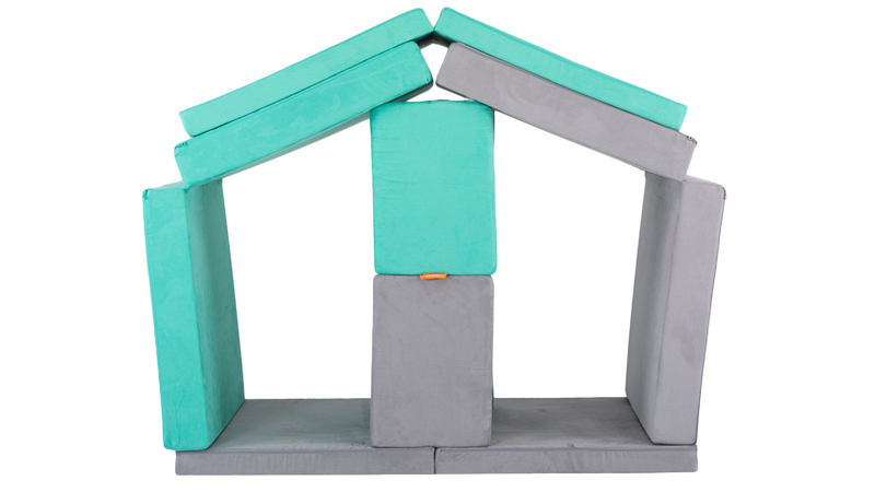 Two Nugget play couches are arranged in a stable build with stalls for pretend horses, ready for imaginative play.