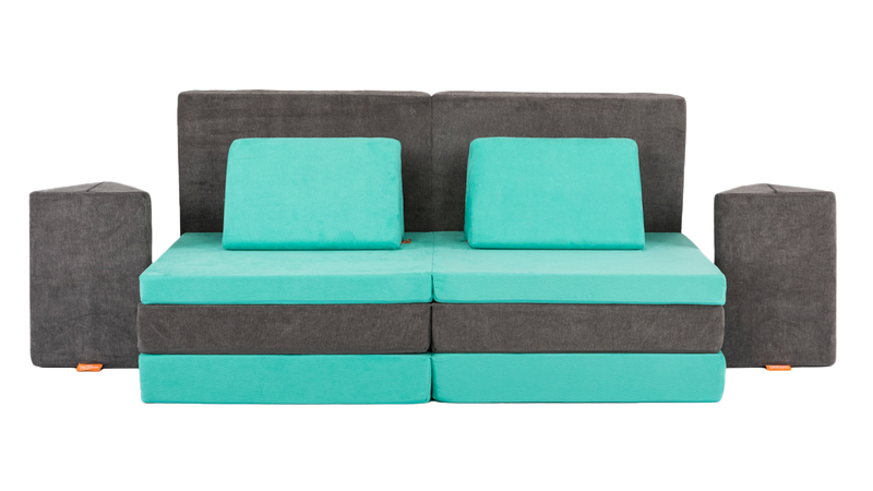Two Nugget play couches are set up as a high-couch build, with the cushions arranged as an elevated platform with side tables.