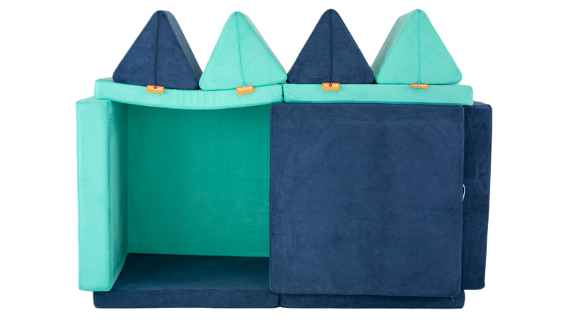 A cozy playroom fort is constructed using two colorful Nugget play couches.