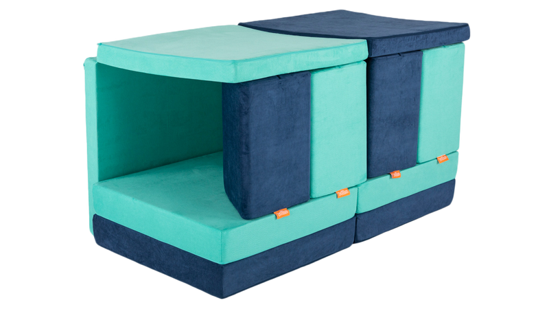 Two Nugget play couches are arranged as a tunnel build, creating a cozy spot for kids to play.