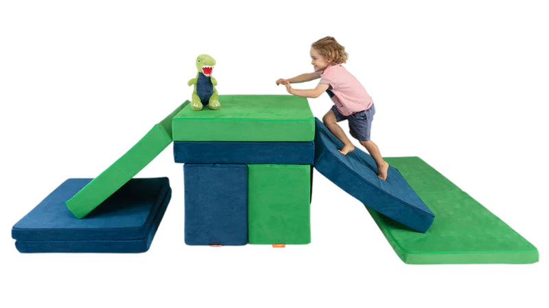 A child plays with a stuffed animal in a sturdy two-Nugget build resembling a plateau.