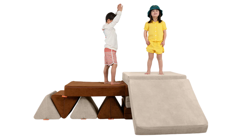 Two children play on a platform build, constructed with two Nugget play couches.
