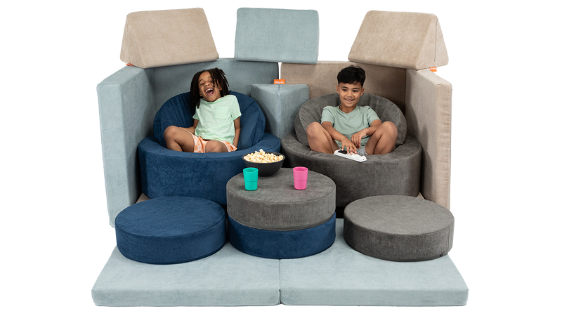 Two children eat popcorn and cozy up for a movie using theatre seating made from two Nuggets and two Chunks.