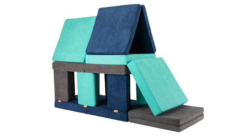 Three Nugget play couches form a two-story pillow fort out of the modular foam couch pieces.