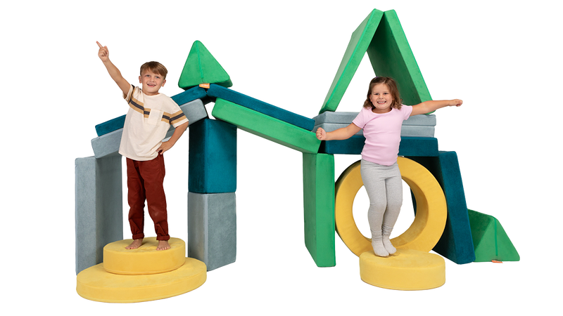 Two children strike a pose on a Nugget fort built from three Nuggets & one Chunk, complete with two stories & three tunnels.