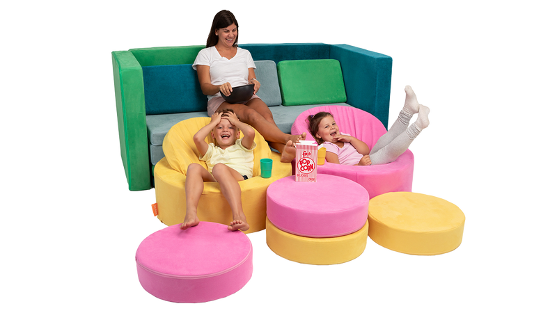 A parent and two children eat popcorn and laugh at a movie from inside theatre seating made from 3 Nuggets and 2 Chunks.