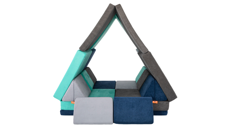 Four Nugget play couches are combined to form a Nugget fort resembling a giant tent, ready for imaginative play.