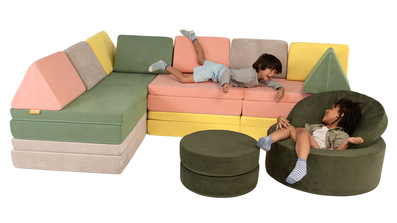 Two children get silly on a play couch sectional build with a Chunk play ottoman — play furniture imaginative play in action.